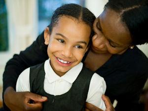 Mother hugging daughter